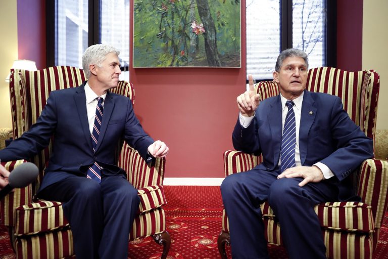 Supreme Court Justice nominee Neil Gorsuch, left, listens as Sen. Joe Manchin, D-W.Va., answers a reporter's question during their meeting on Capitol Hill, Wednesday, Feb. 1, 2017 in Washington. (AP Photo/Alex Brandon)