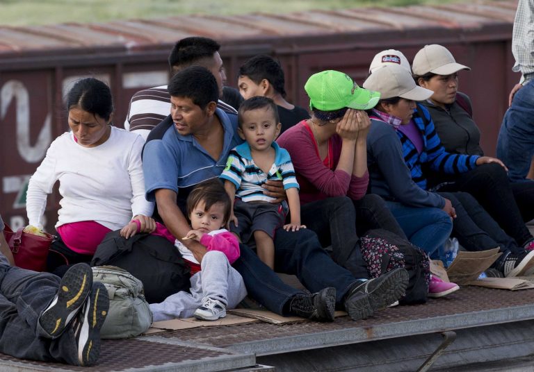 Central American migrants ride a freight train during their journey toward the U.S.-Mexico border in Ixtepec, Mexico, in this July 12, 2014, photo. (AP Photo/Eduardo Verdugo)