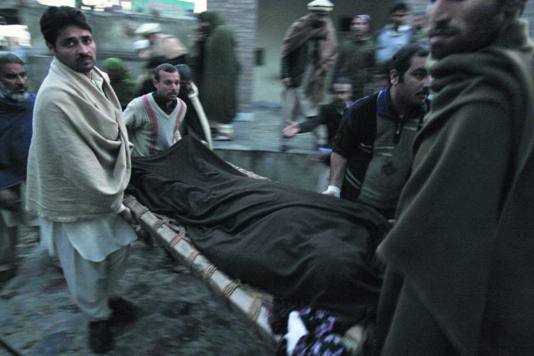 Pakistani men carry the body of a teacher, who was killed by gunmen, from a hospital for burial in Swabi, Pakistan, Tuesday, Jan. 1, 2013. Gunmen in northwest Pakistan killed five female teachers and two aid workers on Tuesday in an ambush on a van carrying workers home from their jobs at a community center, officials said. (AP Photo/Mohammad Sajjad)