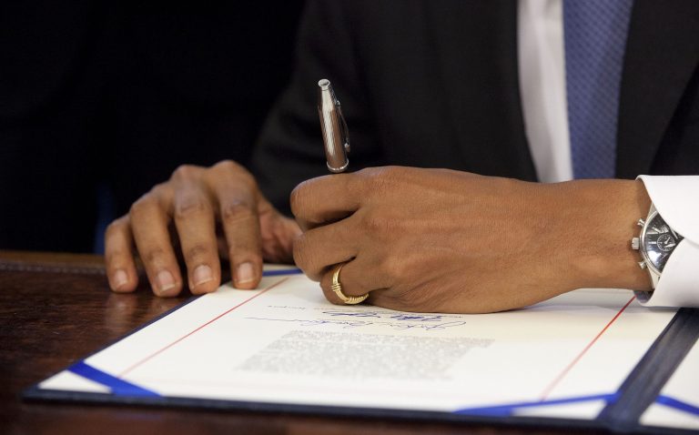 A close-up of President Barack Obama signing the bipartisan bill to cut student loan interest rates, Friday, Aug. 9, 2013, in the Oval Office of the White House in Washington. The bill has been awaiting Obama's signature since earlier this month, when the House gave it final congressional approval after a drawn-out process to reach a compromise in the Senate. The bill links student loan interest rates to the financial markets. It would offer lower rates for most students now, but higher ones down the line if the economy improves as expected. (AP Photo/Pablo Martinez Monsivais)