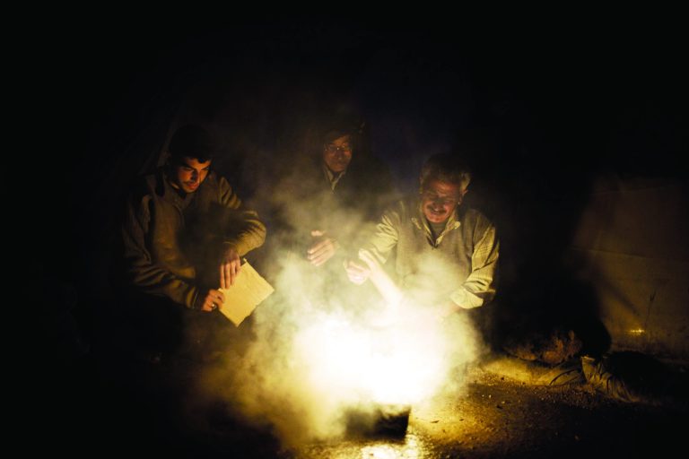 Syrian men heat a fire to boil water near their tent at a refugee camp near the Turkish border, in Azaz, Syria, Sunday, Dec. 9, 2012. (AP Photo/Manu Brabo)