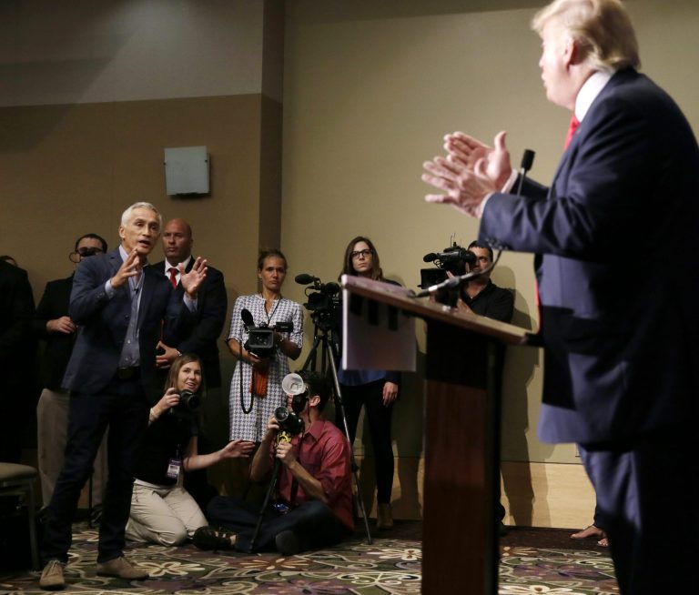 Univision anchor Jorge Ramos, left, asks Republican presidential candidate Donald Trump a question about his immigration proposal during a news conference. (AP Photo/Charlie Neibergall)