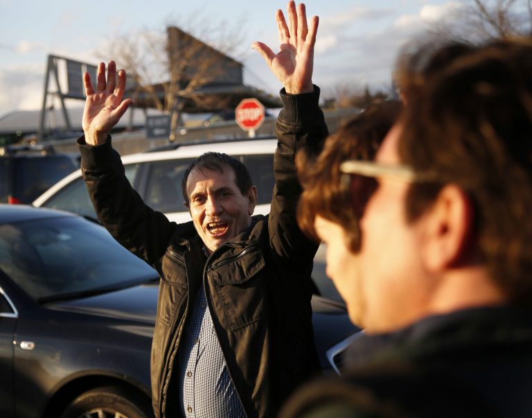 Zabihollah Zarepisheh, of Iran, reacts as he leaves John F. Kennedy International airport in New York, Sunday, Jan. 29, 2017. Attorneys advocating on his behalf said he had been held for more than 30 hours at the airport. President Donald Trump's immigration order sowed more chaos and outrage across the country Sunday, with travelers detained at airports, panicked families searching for relatives and protesters registering opposition to the sweeping measure that was blocked by several federal courts.
		(AP Photo/Seth Wenig)
