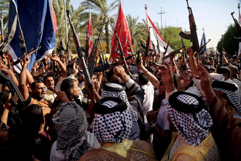 Shiite tribal fighters raise their weapons and chant slogans against the al-Qaida-inspired Islamic State of Iraq and the Levant (ISIL) in Basra, Iraq's second-largest city, 340 miles (550 kilometers) southeast of Baghdad, Iraq, Monday, June 16, 2014. Sunni militants captured a key northern Iraqi town along the highway to Syria early on Monday, compounding the woes of Iraq's Shiite-led government a week after it lost a vast swath of territory to the insurgents in the country's north. (AP Photo/Nabil Al-Jurani)