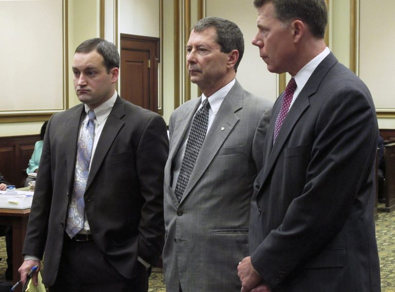 Ohio state representative Pete Beck, center, stands in Hamilton County Common Pleas Court with his lawyers Chad Ziepfel, left, and Ralph Kohnen during a hearing, Monday, April 7, 2014, in Cincinnati. The southwestern Ohio lawmaker is charged with misleading investors about a company's financial status and using their money for personal gain. Beck pleaded not guilty in July to 16 felony counts. A trial date has yet to be set. (AP Photo/Amanda Myers)