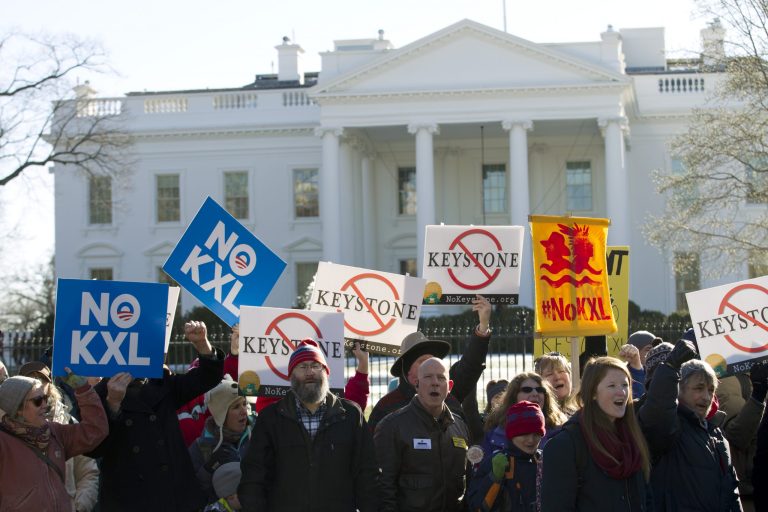 Dozens of demonstrators rally in support of Obama's pledge to veto any legislation approving the Keystone XL pipeline, outside the White House in Washington on Saturday, Jan. 10, 2015. (AP Photo/Jose Luis Magana)