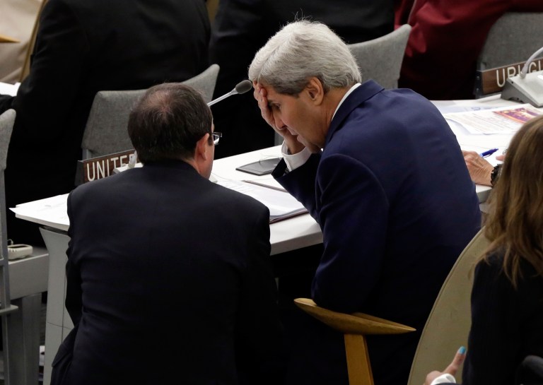 U.S. Secretary of State John Kerry, right, confers in the United Nations General Assembly after his address to the High Level Meeting on Disability and Development, during the 68th session of the General Assembly on Monday. (AP Photo/Richard Drew)