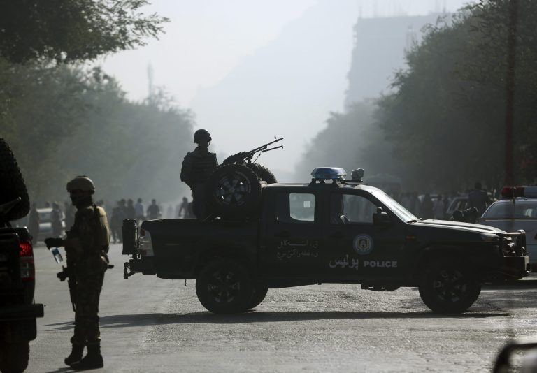 Afghan security forces guard the site of a suicide attack in Kabul, Afghanistan, Wednesday, Oct. 1, 2014. Two suicide bombers in the Afghan capital targeted two buses carrying Afghan army troops on Wednesday, killing several people and wounding over a dozen others, police said. (AP Photo/Massoud Hossaini)