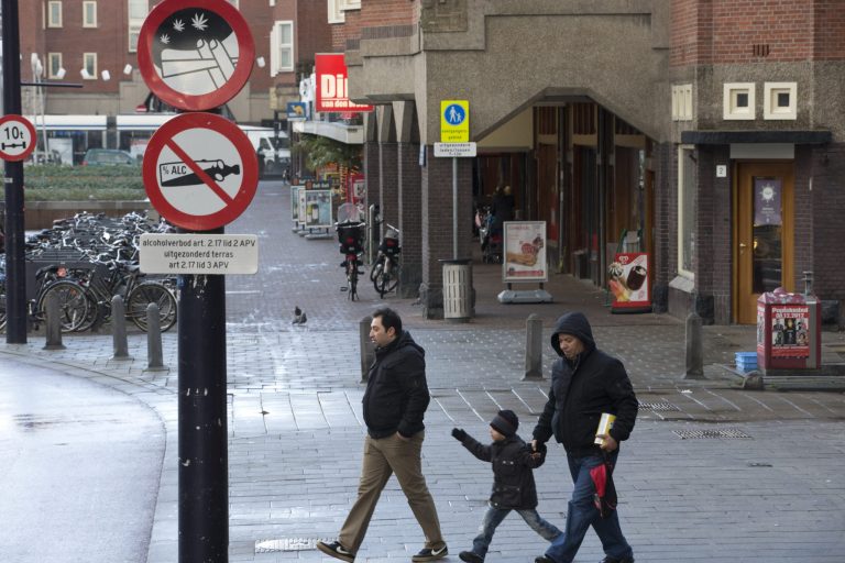   Two men and a child cross a street as a sign prohibiting the use of marijuana in a designated area, top, is seen in Amsterdam, Wednesday Dec. 12, 2012. Amsterdamâs mayor Eeberhard van der Laan said Wednesday he would formally ban students from smoking marijuana at school as of Jan. 1, 2013, making the the Dutch capital the first city in the Netherlands to do so. Under the âtoleranceâ principle, marijuana is technically illegal here, but police canât prosecute people for possession of small amounts. Thatâs the loophole that made possible Amsterdamâs famed âcoffee shopsâ, cafes where marijuana is sold openly. But it has also had the unwanted side effect that Dutch children are frequently exposed to the drug in public areas. (AP Photo/Peter Dejong)  