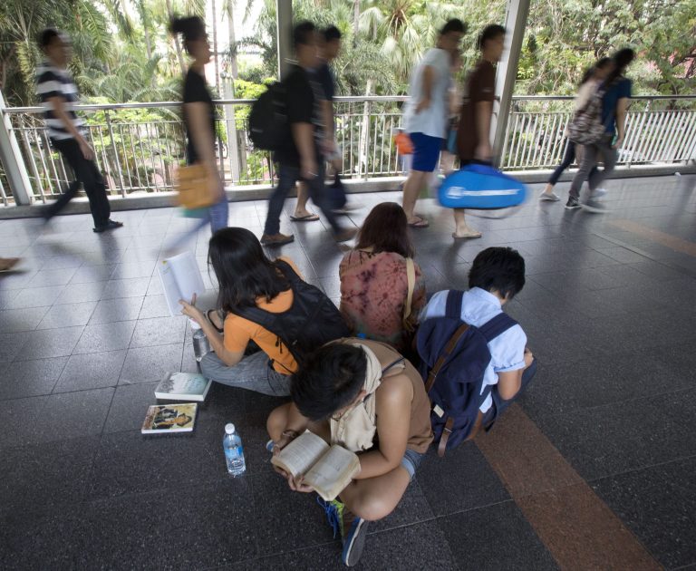 A group of anti-coup protestors read books along an elevated walkway during a protest in Bangkok, Thailand, Saturday, May 31, 2014. In junta-ruled Thailand where the army recently took power in a coup, the simple act of reading in public has become an act of resistance. (AP Photo/Sakchai Lalit)