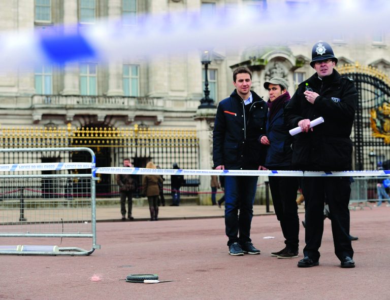 A cornered off area containing knives, a hat and Taser wire outside Buckingham Palace in central London after a man armed with two knives was stunned by police, Sunday Feb. 3, 2013. Scotland Yard said the man, thought to be in his 50s, acted aggressively when challenged by police outside the gates of the heavily touristed landmark on Sunday. Queen Elizabeth II and her husband Prince Philip were at their country retreat, Sandringham Estate, at the time. (AP Photo/Jonathan Brady/PA) UNITED KINGDOM OUT - NO SALES - NO ARCHIVES