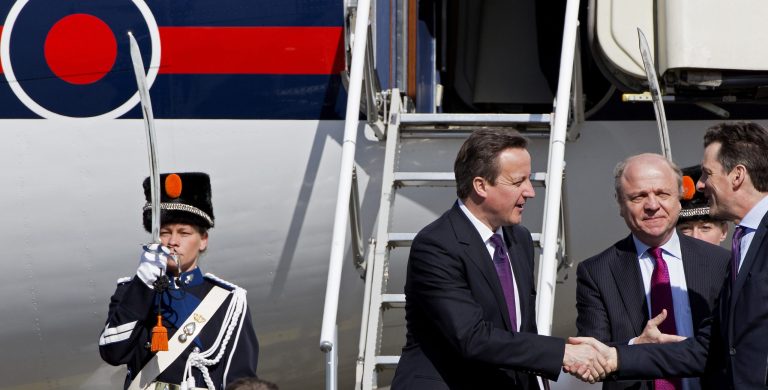 British Prime Minister David Cameron, center, arrives at Schiphol airport in Amsterdam on Monday March 24, 2014 ahead of the March 24-25 Nuclear Security Summit (NSS) in The Hague. (AP Photo/Martijn Beekman, POOL)