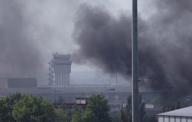 Smoke rises from the airport outside Donetsk, Ukraine, Monday, May 26, 2014. Ukraine's military launched airstrikes Monday against the separatists who had taken over the airport in the eastern city of Donetsk, suggesting that fighting in the east is far from over. (AP Photo/Ivan Sekretarev)