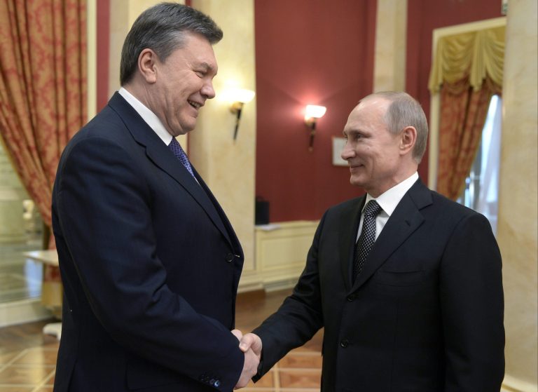 FILE - A Friday, Feb. 7, 2014 photo from files showing Russian President Vladimir Putin, right, shaking hands with Ukrainian President Viktor Yanukovych at the Olympic reception hosted by the Russian President in Sochi, Russia. Russia questioned the legitimacy of the new Ukrainian authorities on Monday, Feb. 24, 2014, with its prime minister saying it sees the turmoil in Ukraine as a threat to both Russian citizens and Russian interests in Ukraine. (AP Photo/RIA-Novosti, Alexei Nikolsky, Presidential Press Service, Pool, File)