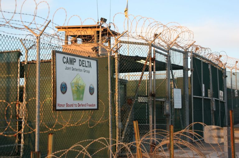 This Oct. 24, 2010, file photo shows the entrance to Camp Delta at Guantanamo Bay. Six men long held at Guantanamo Bay arrived Saturday, June 13, 2015, in Oman, the first movement of detainees out of the U.S. prison for terrorism suspects in five months as Congress considers new restrictions on transfers. (AP Photo/The Canadian Press, Colin Perkel)