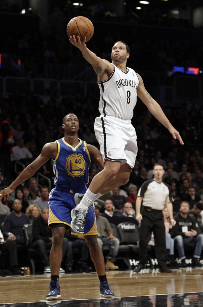   Golden State Warriors forward Harrison Barnes (40) watches from the floor as Brooklyn Nets guard Deron Williams (8) goes up for a layup in the first half of an NBA basketball game at Barclays Center, Friday, Dec. 7, 2012, in New York. (AP Photo/Kathy Willens)  