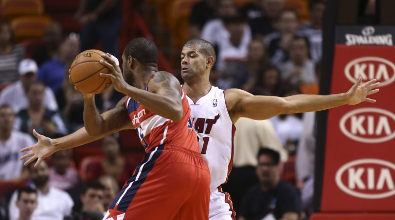 Miami Heat's Shane Batttier (31) blocks Washington Wizards' Trevor Booker (35) during the first half of an NBA basketball game in Miami, Monday, March 10, 2014. (AP Photo/J Pat Carter)