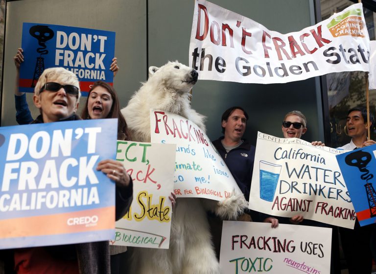Environmental demonstrators protest California Gov. Jerry Brown's position on natural gas fracking, Friday, Sept. 13, 2013, in San Francisco, Calif. (AP Photo/Beck Diefenbach)