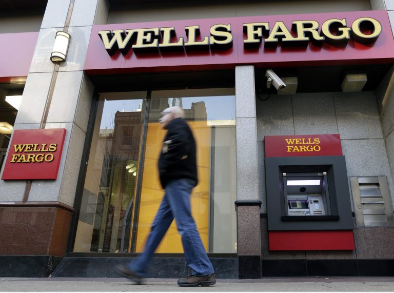 A man walks past a Wells Fargo branch in Philadelphia. Chief Executive Officer Timothy Sloan is working to rebuild the San Francisco-based lender's reputation after a string of settlements over claims of customer exploitation. 