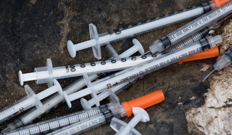 Discarded syringes lay near near train tracks in Philadelphia, Monday, July 31, 2017. According to the Council of Economic Advisers report, more than 50,000 Americans died of a drug overdose in 2015, of which 63 percent reportedly involved opioids. (AP Photo/Matt Rourke)