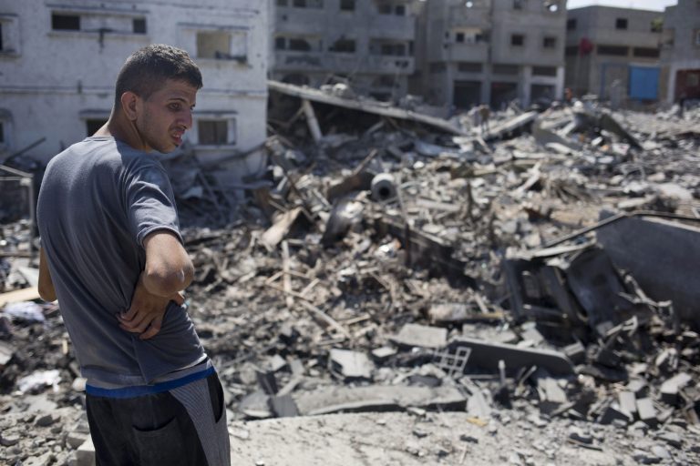 A Palestinian inspects a destroyed house in the heavily bombed Gaza City neighborhood of Shijaiyah, close to the Israeli border, Friday, Aug. 1, 2014. (AP Photo/Dusan Vranic)