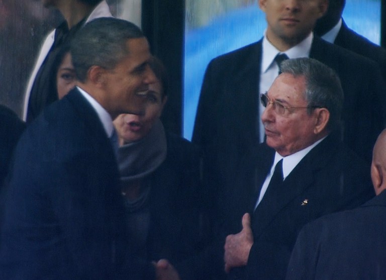 President Obama shakes hands with Cuban President Raul Castro at FNB Stadium in Soweto, South Africa, during a memorial service for former South African President Nelson Mandela on Tuesday. (AP Photo/SABC Pool)