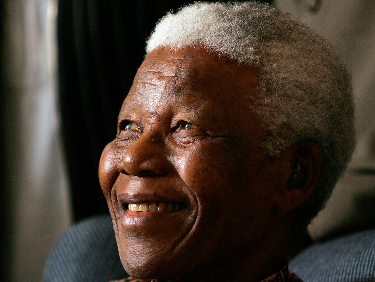 Former South African President Nelson Mandela smiles during a meeting with a group of Mandela Rhodes Scholars in Johannesburg, South Africa, in 2006. (AP Photo/Themba Hadebe)