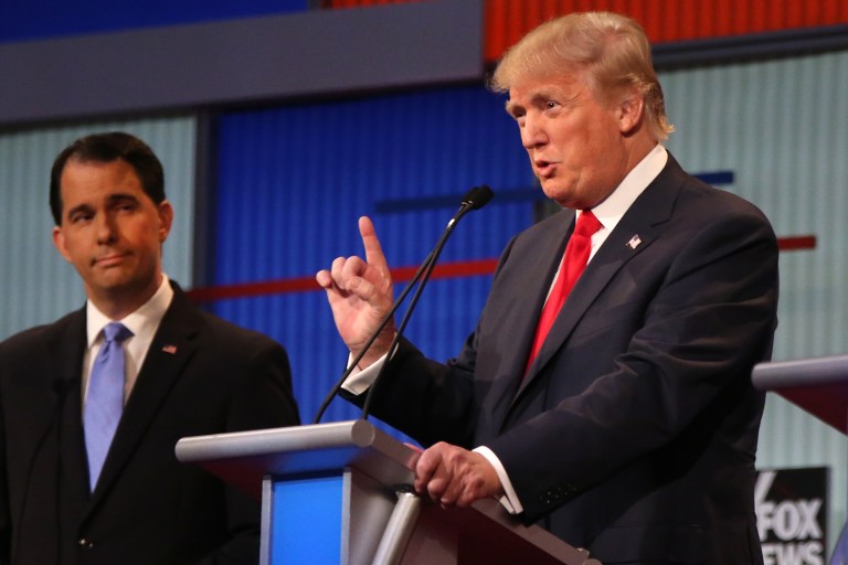 Republican presidential candidate Donald Trump speaks as Wisconsin Gov. Scott Walker listens during the first Republican presidential debate at the Quicken Loans Arena Thursday, Aug. 6, 2015, in Cleveland. (AP Photo/Andrew Harnik)