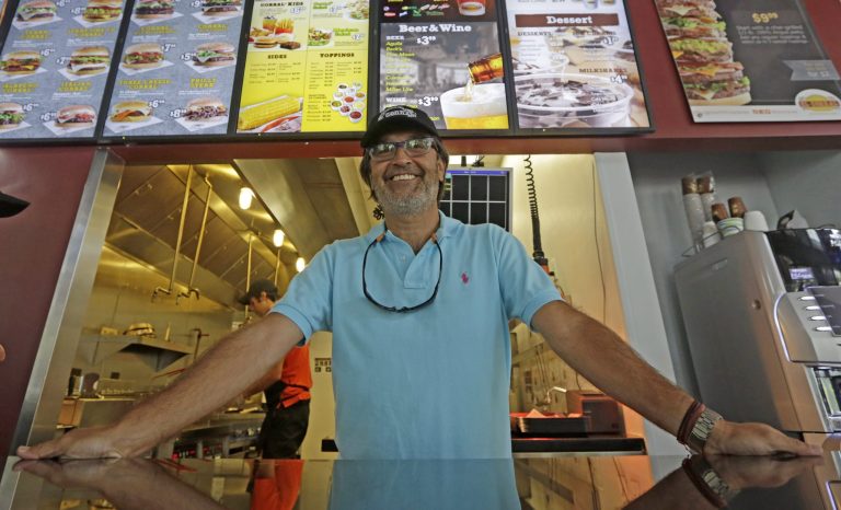 In this photo taken Friday, Aug. 15, 2014, Juan M. Patino, vice-president of 4JS, the franchisee of El Corral in the U.S., poses for a photo at a Corral restaurant in Miami. Colombian hamburger chain El Corral has over 200 locations in Latin America and  arrived to the U.S. in early 2013. (AP Photo/Alan Diaz)