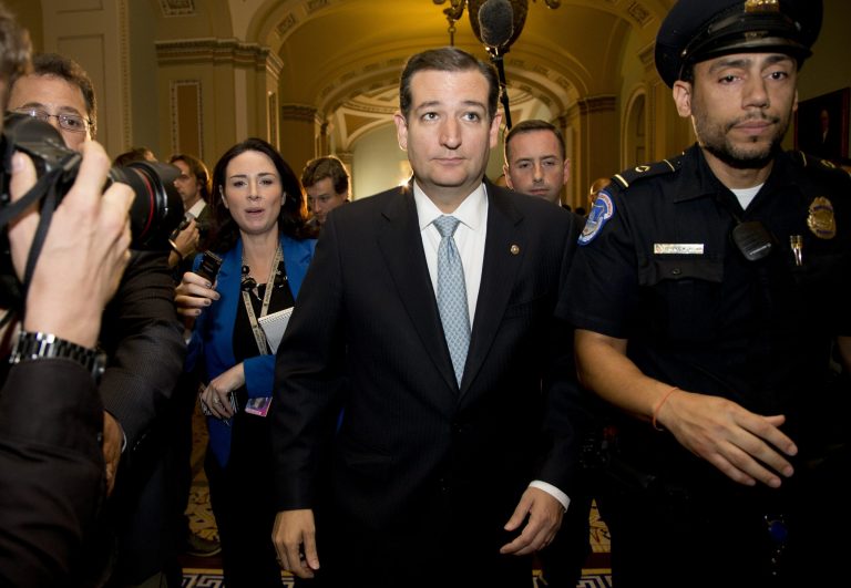 Sen. Ted Cruz, R-Texas, walks with security after talking to reporters on Capitol Hill. Cruz led theÃÂ push in the Republican party to shut down the government in an attempt to delay or defund the health care law.ÃÂ (AP Photo/Carolyn Kaster)