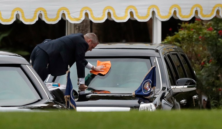 A U.S. Secret Service special agent cleans the windshield of the presidential limousine at Mar-a-Lago, Friday, March 3, 2017, in Palm Beach, Fla. (AP Photo/Alex Brandon)