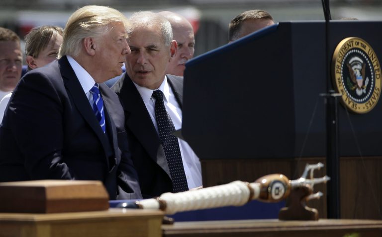 After posing with the saber, Trump sat down next to Kelly, who leaned in and joked, 