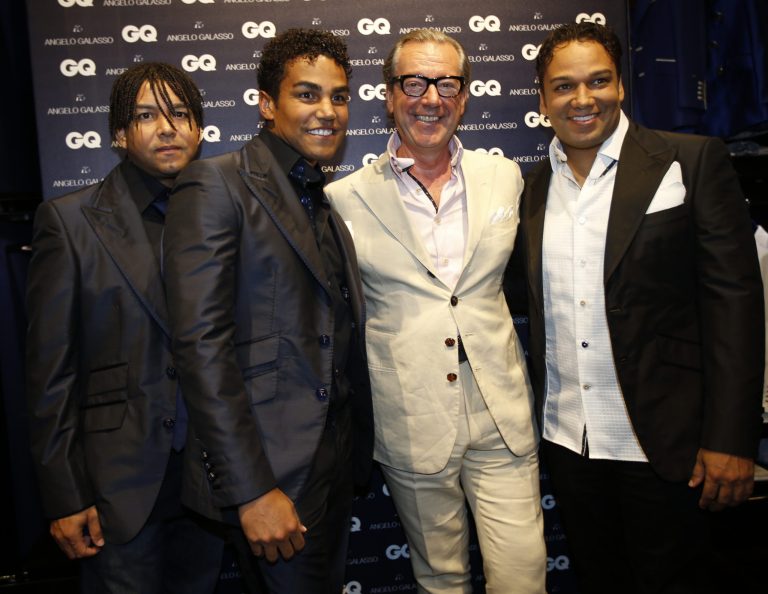 3T pop group members from left, Taj, TJ and Taryll, nephews of late pop star Michael Jackson pose with Italian fashion designer Angelo Galasso, second right, as they attend a presentation of Angelo Galasso men's Spring-Summer 2015 collection, part of the Milan Fashion Week, unveiled in Milan, Italy, Monday, June 23, 2014. (AP Photo/Luca Bruno)
