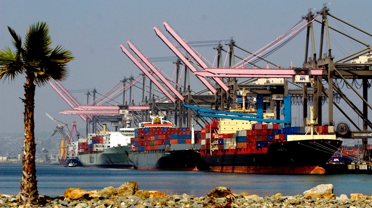 FILE - In this Sept. 10, 2004 file photo, ships carrying containers are loaded and unloaded at the Port of Los Angeles. The nation's busiest port is approving Thursday, June 5, 2014 a new director and a nearly $1 billion budget that focuses on construction projects to keep business from increasingly aggressive competitors. (AP Photo/Reed Saxon, File)