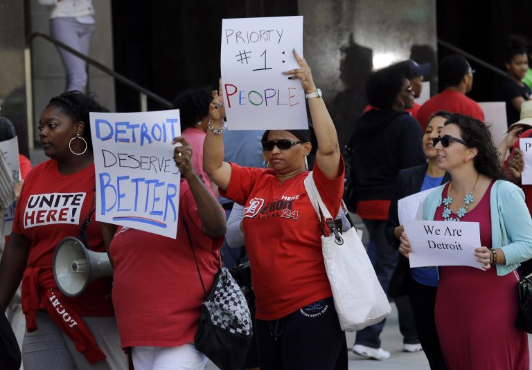 Protesters march outside the Theodore Levin United States Courthouse, in Detroit on July 24. (AP/Paul Sancya)