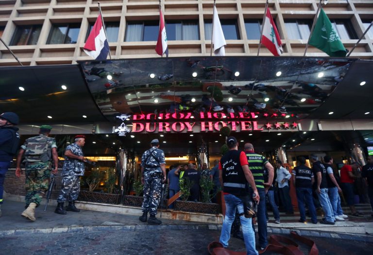 Lebanese army and plainclothes policemen gather outside the Duroy hotel where a suicide bomber blew himself up in his room, in Beirut, Lebanon, Wednesday, June 25, 2014, as Lebanese security forces raided the premises. The bombing is the latest in a string of attacks and security sweeps in Lebanon over the past week that have sparked fears of renewed violence in a country that has been deeply affected by the civil war in neighboring Syria. (AP Photo/Bilal Hussein)