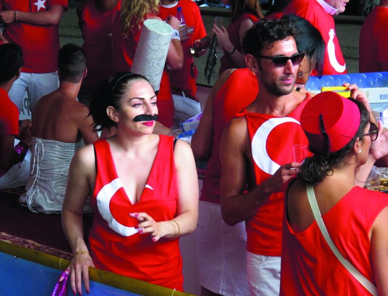 Turkish participants wait for the start of the Canal Parade on a boat at Prinsengracht in Amsterdam, Netherlands, Saturday Aug. 4, 2012. Hundreds of thousands of gay rights supporters are thronging Amsterdam's canals for the city's annual boat float parade, a party marking the high point of Gay Pride week. This year Dutch homosexuals of Turkish ancestry have their own float, a first. (AP Photo/Margriet Faber)