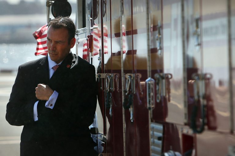 A Secret Service agent covers up from the wind as Marine One lands in New York City with President Barack Obama. (Photo by Spencer Platt/Getty Images)