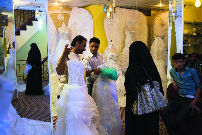 Yemeni women shop for wedding dresses in Sanaa, Yemen, Wednesday, Dec. 26, 2012. While most Yemeni women don the traditional niqab, gender separated weddings bring out the latest in western-style wedding dresses. (AP Photo/Alex Potter)