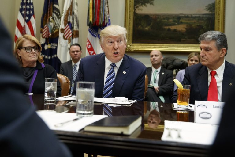 President Donald Trump, flanked by Sen. Heidi Heitkamp, D-N.D., left, and Sen. Joe Manchin, D-W.Va., speaks during a meeting with Senators on his Supreme Court Justice nominee Neil Gorsuch, Thursday, Feb. 9, 2017, in the Roosevelt Room of the White House in Washington. (AP Photo/Evan Vucci)
