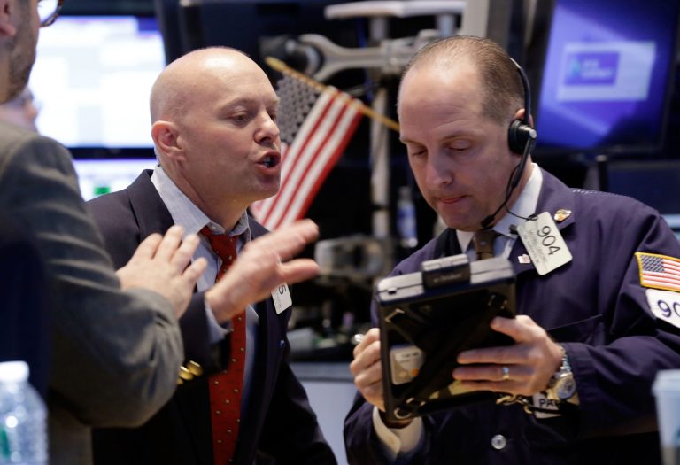 Traders Daniel Leporin, left, and Michael Urkonis work on the floor of the New York Stock Exchange Wednesday, April 23, 2014. The stock market slipped Wednesday after rallying for six straight days as investors worked through another round of quarterly earnings reports from U.S. companies. (AP Photo/Richard Drew)