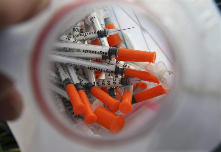 Local governments need naloxone as an antidote to heroin overdoses, but the price is soaring. (AP Photo/Mel Evans)