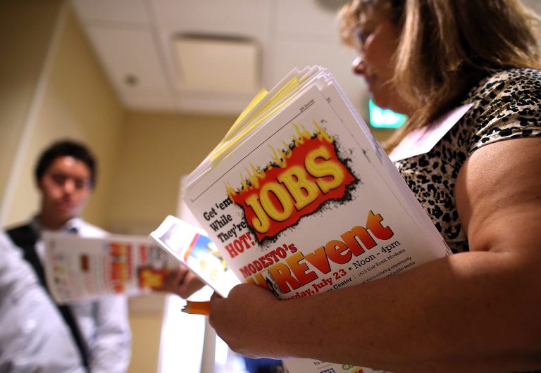 EMERYVILLE, CA - JULY 17:  Karen Dawal passes out information to job seekers during the East Bay's HIREvent on July 17, 2013 in Emeryville, California.  Dozens of job seekers attended the East Bay's HIREvent where several employers were recruiting for a variety of public and private-sector jobs.  (Photo by Justin Sullivan/Getty Images)