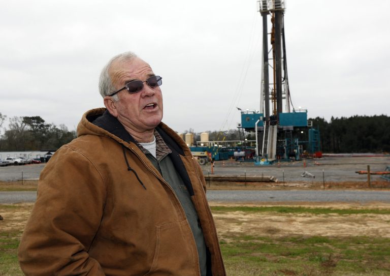 In this Dec. 23, 2013 photograph, Amite County Supervisor Max Lawson describes the convoy of about 200 trucks carting in a drilling rig and other gear on what was pasture land at his Gillsburg, Miss., farm. After a little more than a two-year wait, Encana Corp., contractors were finally drilling. Oil companies plan a big increase in drilling activity in 2014 in southwest Mississippi. They're trying to extract oil from a formation called the Tuscaloosa Marine Shale, which one study says could hold 7 billion barrels. (AP Photo/Rogelio V. Solis)