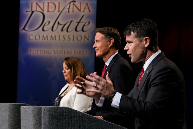 The three candidates for Indiana's open U.S. Senate seat, from left, Libertarian Lucy Brenton, Democrat Evan Bayh and Republican Todd Young participate in debate in Indianapolis, Tuesday, Oct. 18, 2016. The Indiana campaign has become a key national race as Democrats try to capture the seat now held by retiring Republican Sen. Dan Coats and overturn the GOP's narrow Senate majority. (AP Photo/Michael Conroy, Pool)