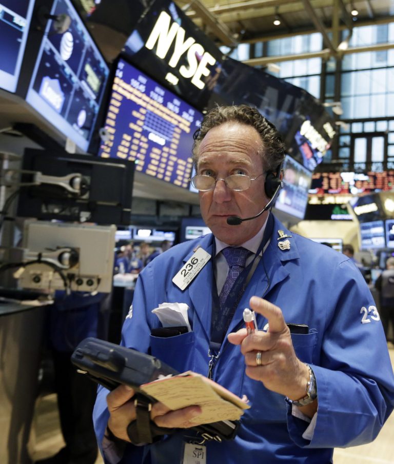 Trader Steven Kaplan works on the floor of the New York Stock Exchange Wednesday, March 12, 2014. Asian stock markets vacillated Thursday March 27, 2014 as investors waited to see if weak Chinese economic data might prompt new economic stimulus. European shares drifted down.  (AP Photo/Richard Drew)