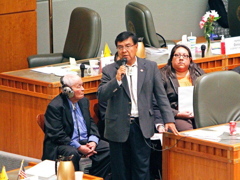 Rep. James Roger Madalena speaks on the Navoajo Nation's gambling agreement while Sen. John Pinto, left, and Attorney Karis N. Begaye, right listen on the House floor at the state Capitol, Tuesday, Feb. 18, 2014, in Santa Fe, N.M. The New Mexico House approved the tribal-state compact that would allow the Navajos to open three additional casinos over 15 years. The proposal goes to the Senate for consideration. Lawmakers adjourn on Thursday. (AP Photo/The Santa Fe New Mexican, Jane Phillips)