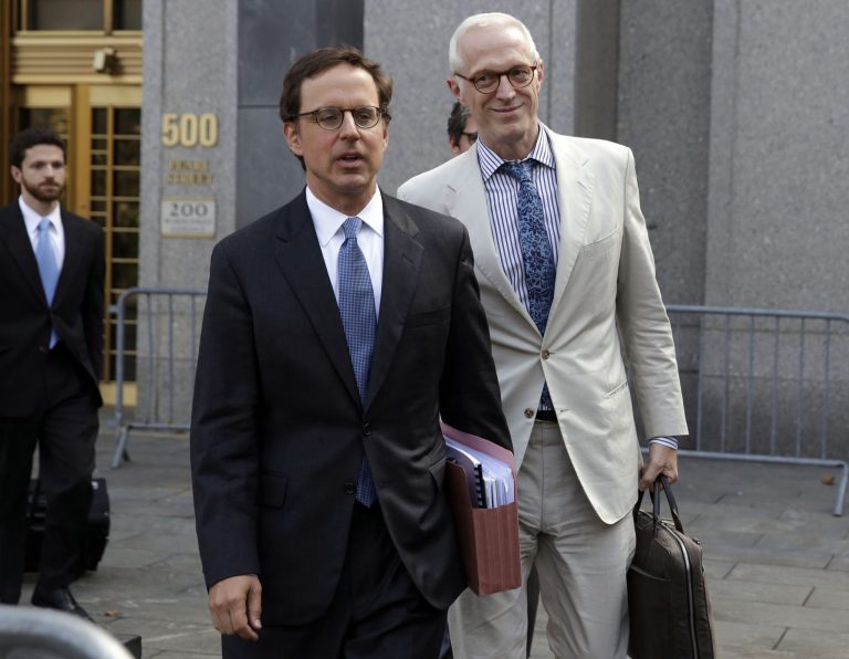 Carmine Boccuzzi, center, a lawyer representing Argentina, leaves Federal court after a hearing, in New York,  Thursday, Aug. 21, 2014. Argentina will make its next round of scheduled debt payments, the economy minister said as he defends a new plan to pay creditors locally and avoid the jurisdiction of a U.S. court that forced the country into default last month. (AP Photo/Richard Drew)