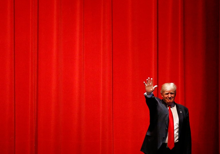 Republican presidential candidate Donald Trump waves as he walks onstage before speaking at a campaign event at St. Norbert College in De Pere, Wis., Wednesday, March 30, 2016. (AP Photo/Patrick Semansky)