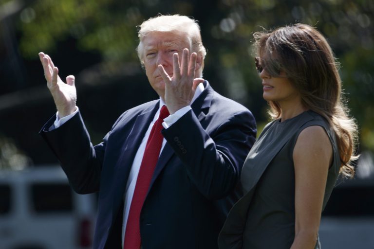 President Donald Trump gestures towards reporters as he walks with first lady Melania Trump to board Marine One on the South Lawn of the White House, Friday, Sept. 8, 2017, in Washington. (AP Photo/Evan Vucci)